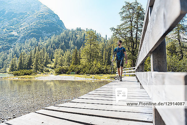 Austria  Tyrol  Hiker at Lake Seebensee walking on boardwalk