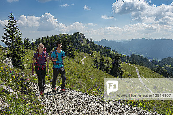 Germany  Bavaria  Brauneck near Lenggries  young couple hiking in alpine landscape