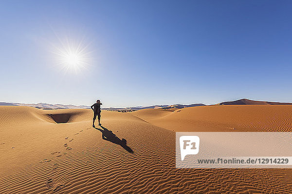 Africa  Namibia  Namib desert  Naukluft National Park  female tourist walking on dune