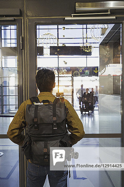 Young man with backpack standing at the airport