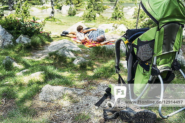 Spain  Father and daughter lying on a blanket  resting in nature