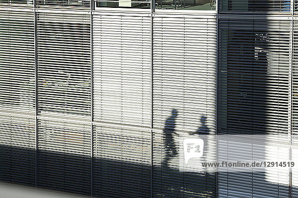 Shadow of two businessmen on a sunblind