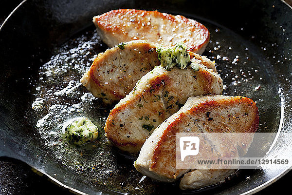 Fillet of turkey with herb butter in pan