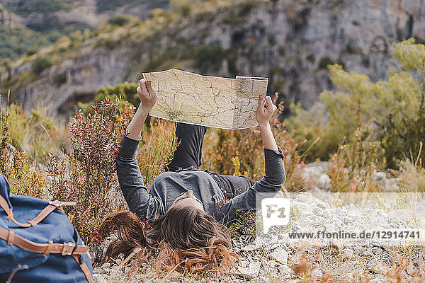 Spain  Alquezar  young woman with hiking map in nature