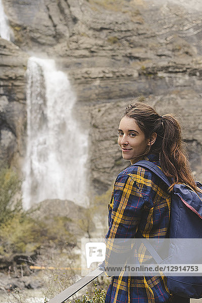 Spain  Ordesa y Monte Perdido National Park  portrait of smiling young woman with backpack