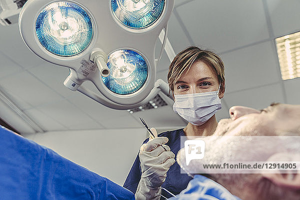 Dental surgeon during surgical procedure on a patient