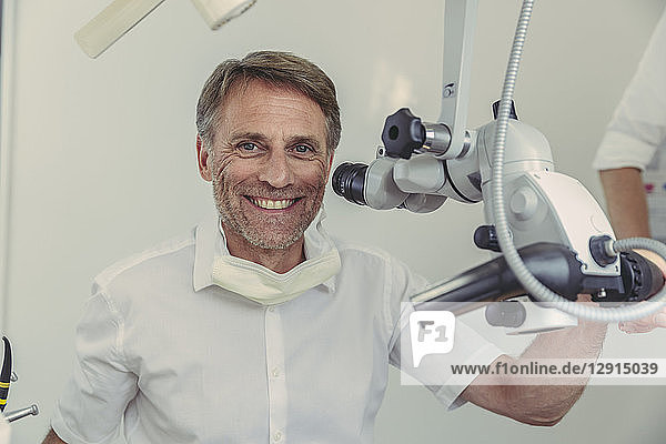 Dentist using microscope  portrait
