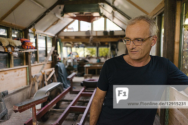 Portrait of a mature man in his workshop