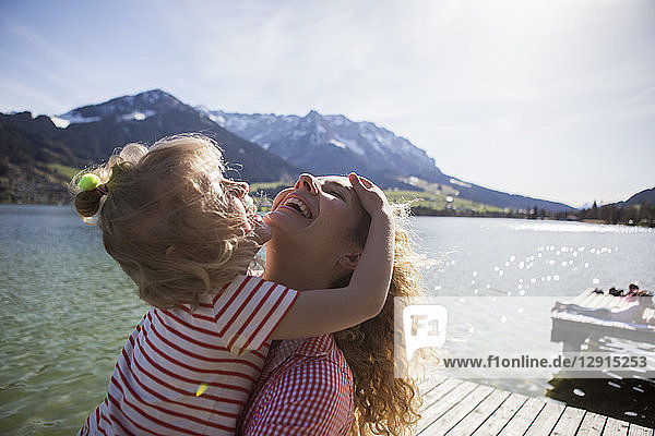 Austria  Tyrol  Walchsee  happy mother with daughter at the lake