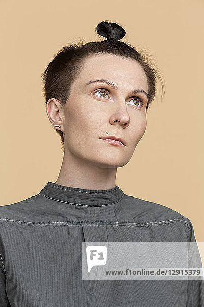 Portrait of serious woman with short hair and braid
