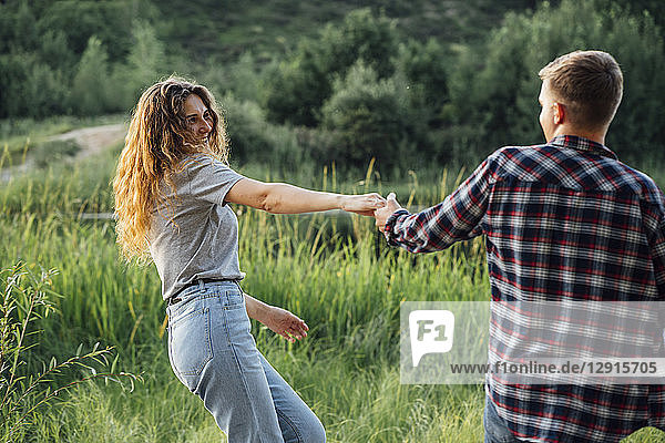 Romantic couple spending time in nature  holding hands