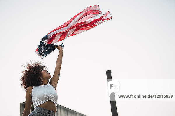Young woman waving American flag