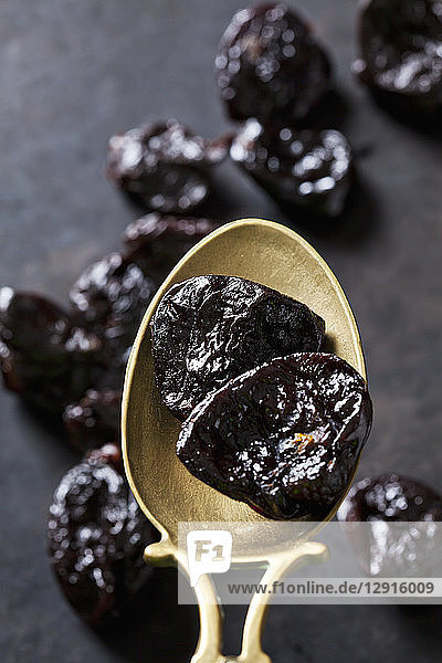 Prunes on a vintage brass spoon