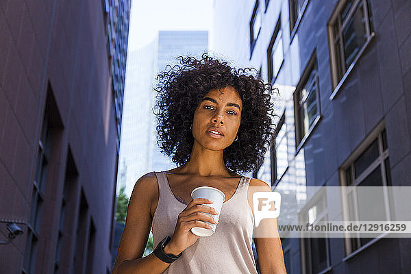 Germany  Frankfurt  portrait of young woman with coffee to go in the city