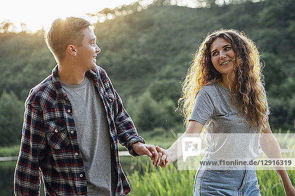 Romantic couple spending time in nature  holding hands