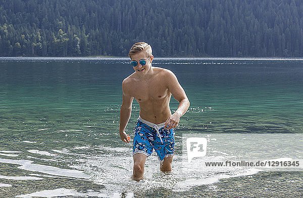 Germany  Bavaria  Eibsee  young man coming out of water