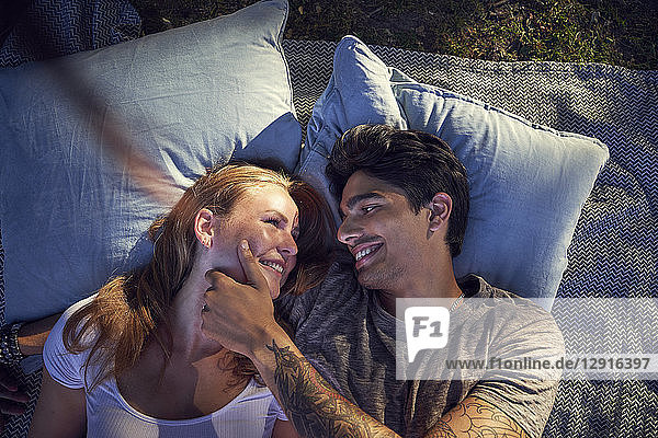 Young couple in love  lying on cushions