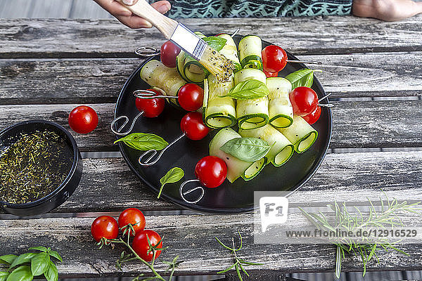 Vegetarian grill skewers  tomato and zucchini slices  brush with rosemary garlic oil