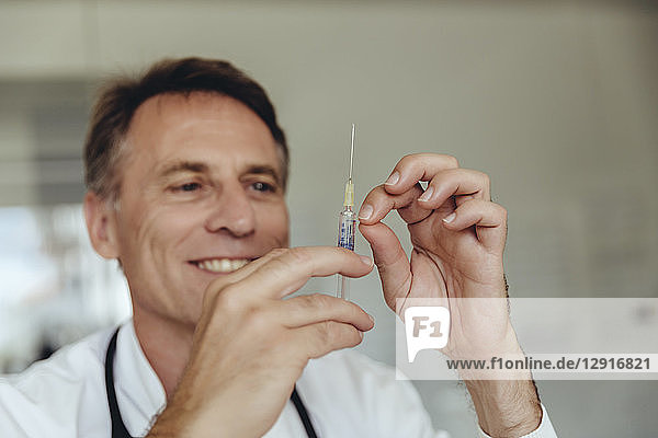 Doctor preparing injection  filling syringe