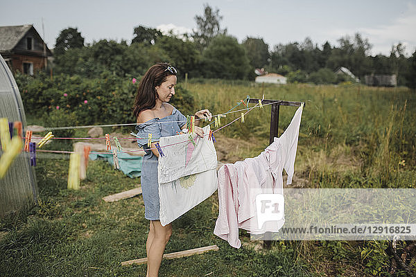 Woman hanging up laundry in garden