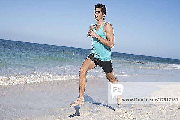 Spain  Canary Islands  Fuerteventura  young man running on the beach