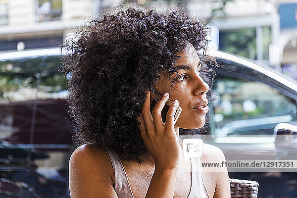 Germany  Frankfurt  portrait of young woman with curly on the phone