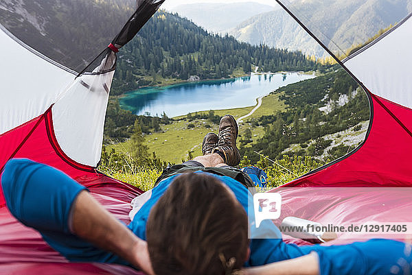 Austria  Tyrol  Hiker relaxing in his tent in the mountains at Lake Seebensee