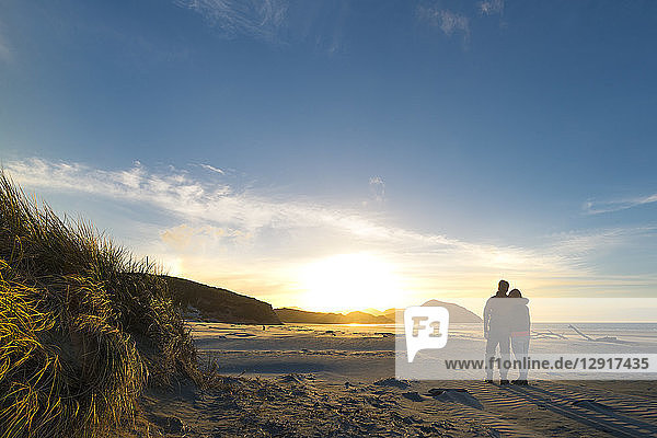 New Zealand  South Island  Puponga  Wharariki Beach  Couple on the beach at sunset