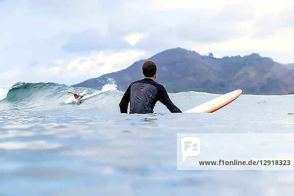 View of two men surfing in sea