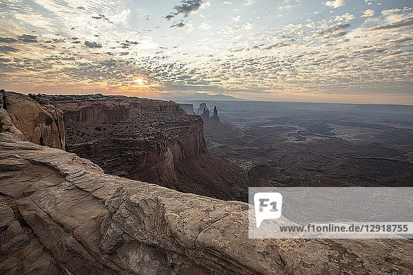 Majestic natural scenery of canyon at sunrise at Mesa Arch in Canyonlands National Park Moab Utah USA
