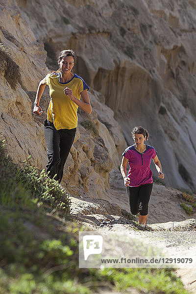 Two women running in sandstone area near Torrey Pines State Park in La Jolla  San Diego  California  USA