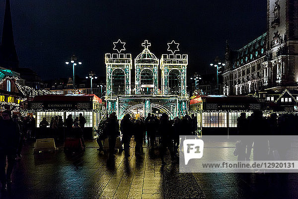 The entrance to Hamburg's Rathaus Christmas Market (Weihnachtsmarkt Rathausmarkt) at night  Hamburg  Germany