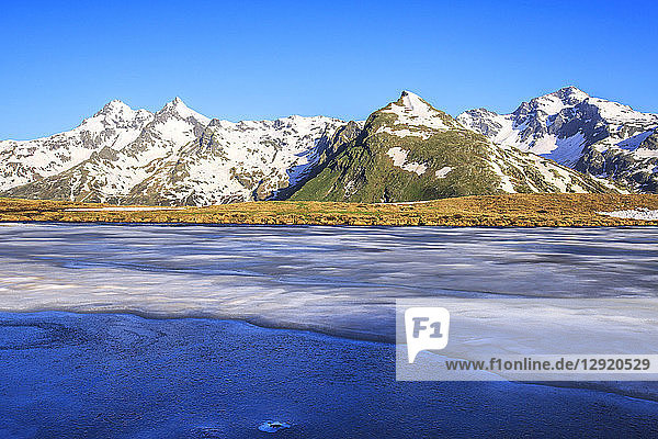 Ice melting at Lake Andossi during thaw Chiavenna Valley Spluga Valley Sondrio province Valtellina Lombardy Italy