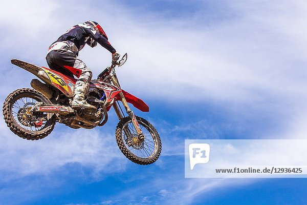 . Motocross Driver jumping in a race. Colombia. South America.