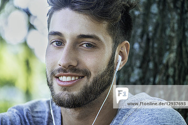 Close-up of young man listening to music