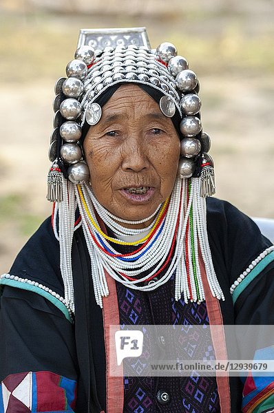 Old local woman from the tribe of the Akha with typical headdress  portrait  Hokyin Akha Village  near Kyaing Tong  Shan State  Golden Triangle  Myanmar