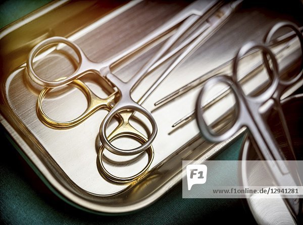 Some scissors for surgery on a tray in an operating theater  conceptual image.