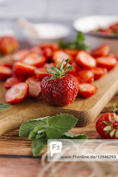Strawberries on a wooden board (cleaned and sliced)