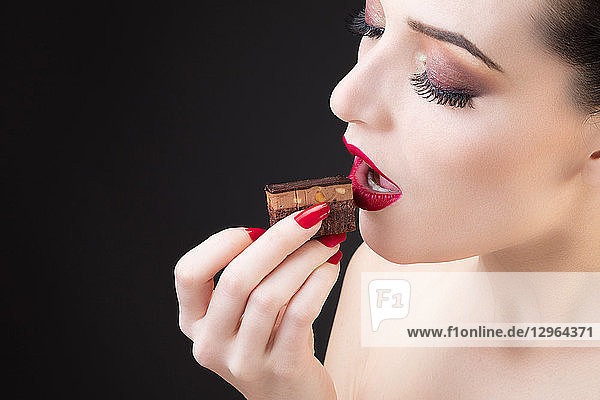 Tight shot of girl tasting chocolate cake