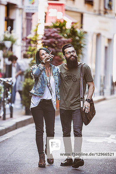 Young hipster couple walking down the street