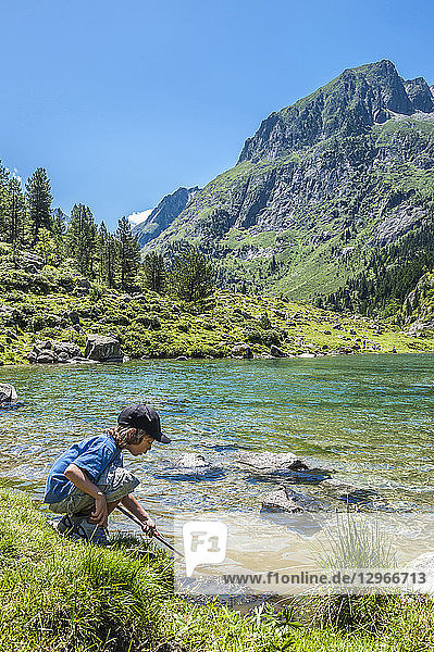 France  Pyrenees National Park  Occitanie region  Val d'Azun  6-year-old boy by the Suyen lake on the gave d'Arrens (name referring to torrential rivers  in the west side of the Pyrenees)