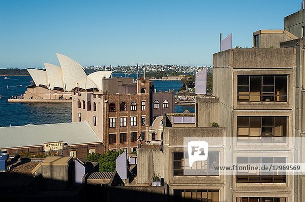 Sydney  New South Wales  Australia - An elevated view from Sydney Harbour Bridge of buildings in the urban locality of The Rocks and the Sydney Opera House on Bennelong Point in the backdrop.