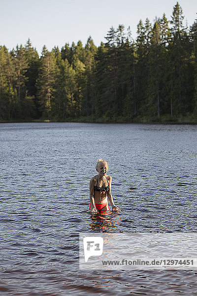 Girl swimming in a lake in Kilsbergen Sweden