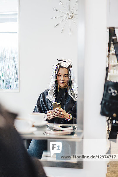 Hairdressing client with foil in hair in Sweden