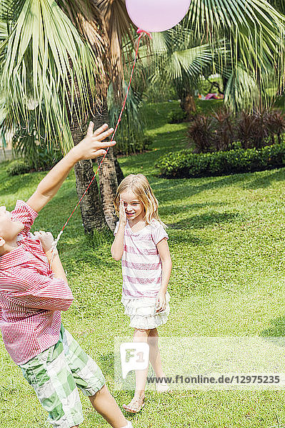 Children with balloon in park