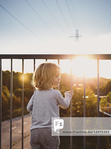 Girl standing on a balcony at sunset in Skarpnack Sweden