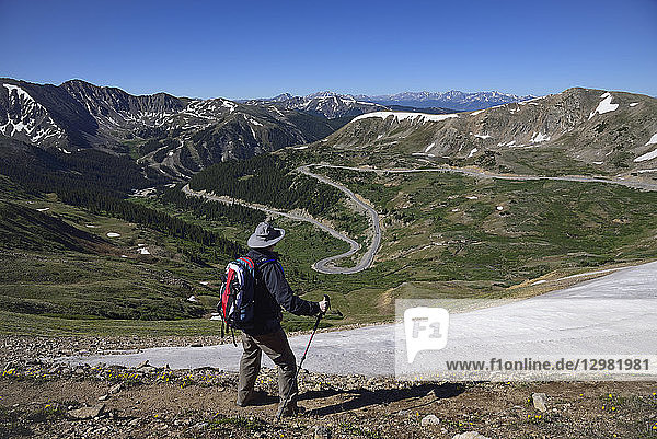 Hiker looking at view of mountains at Loveland Pass in Colorado