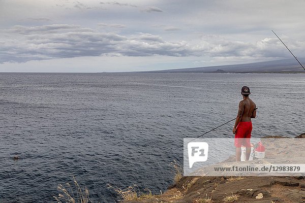 Ka Lae  Hawaii - A man fishes from a 40-foot cliff at South Point  the southernmost point in the United States  on Hawaii's Big Island.