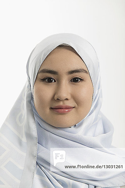 Portrait smiling  confident young woman in blue silk hijab
