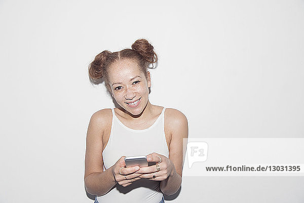 Portrait smiling  confident young woman texting with smart phone